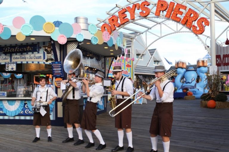 A band plays German music while dressed in lederhosen during Oktoberfest.