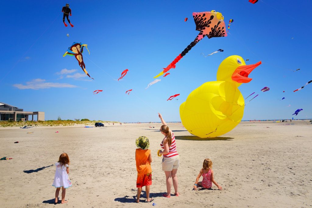 A family watches an array of kites float in the air during the Wildwoods International Kite Festival.