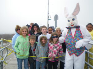 Children smile with the Easter Bunny during a Wildwoods Easter egg hunt.
