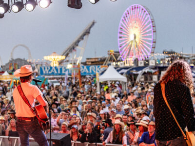 Country musicians playing to a large crown on the boardwalk oceanfront at the Barefoot Country Music Festival in the Wildwoods NJ