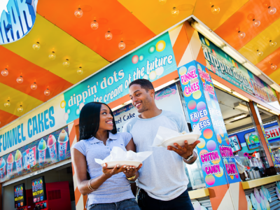 A couple on the boardwalk in the Wildwoods enjoying snacks