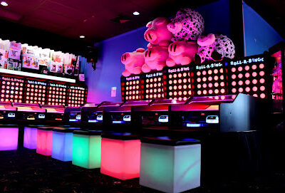 Colorful and bright roll-a-bingo machines at an arcade