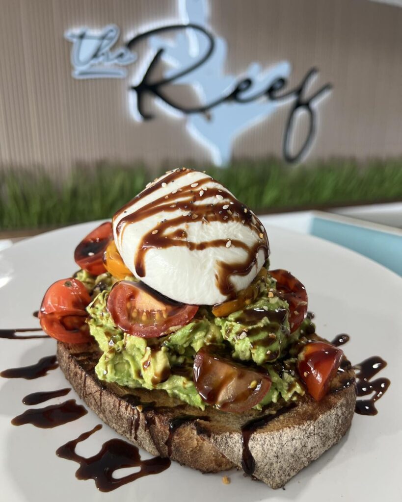 Avocado toast stacked tall from Reef Restaurant