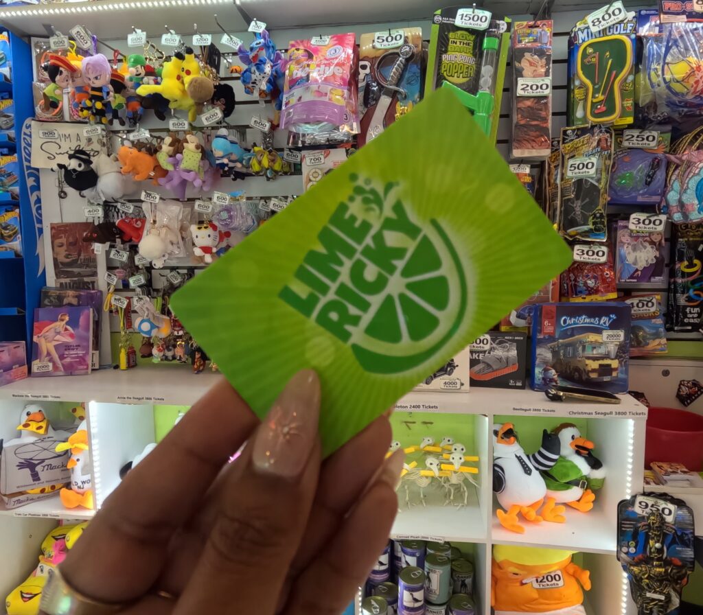 A hand holding a card from Lime Ricky Arcade